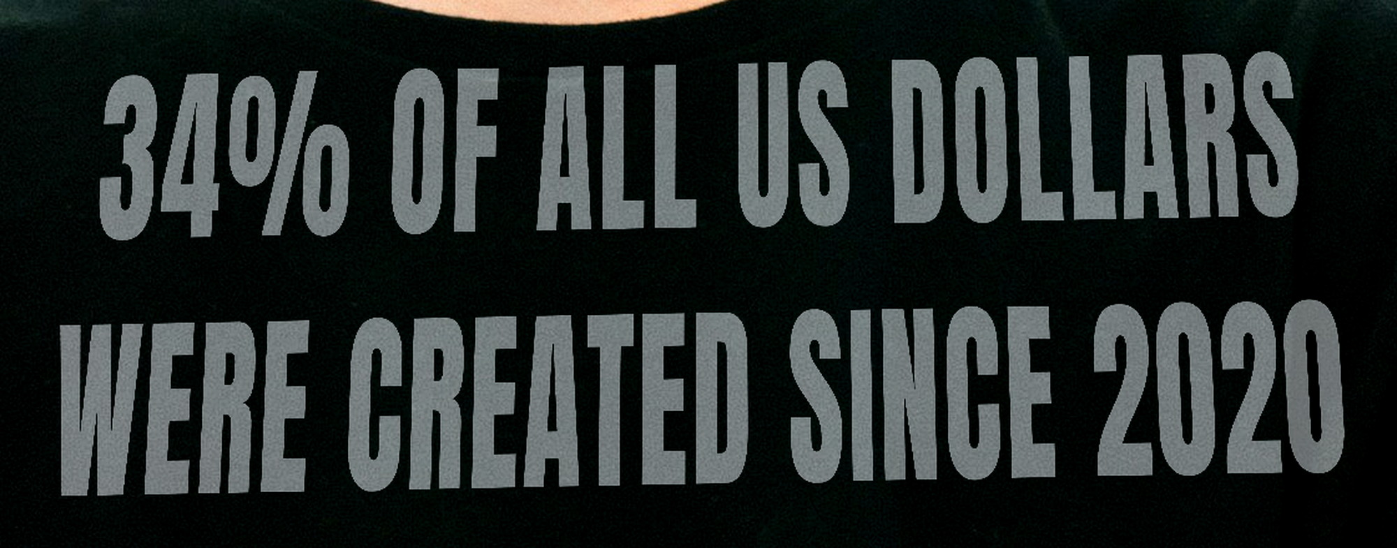 Close-up of front type on black cotton